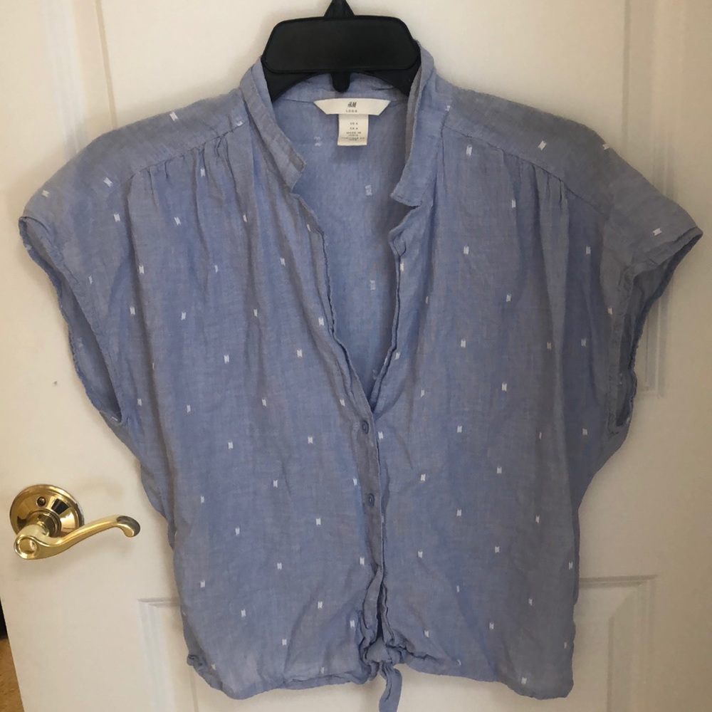 Blue, sleeveless top with small white accents